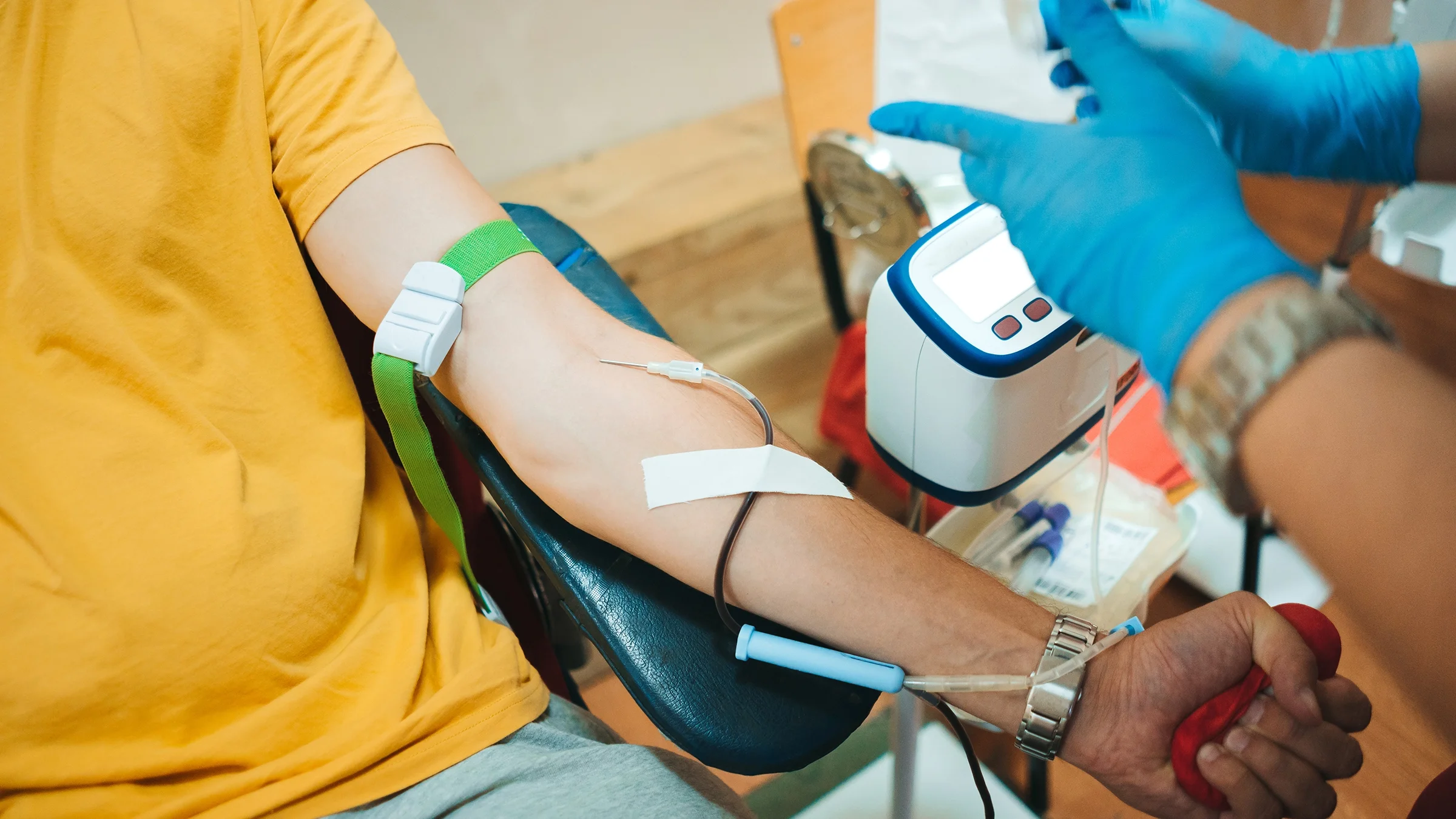 A person is getting their blood drawn in a close-up.
