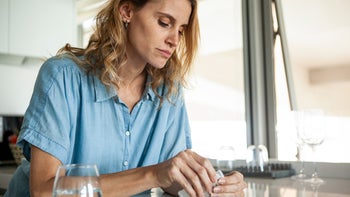 atomoxetine: woman with blister pack of pills 1321004577