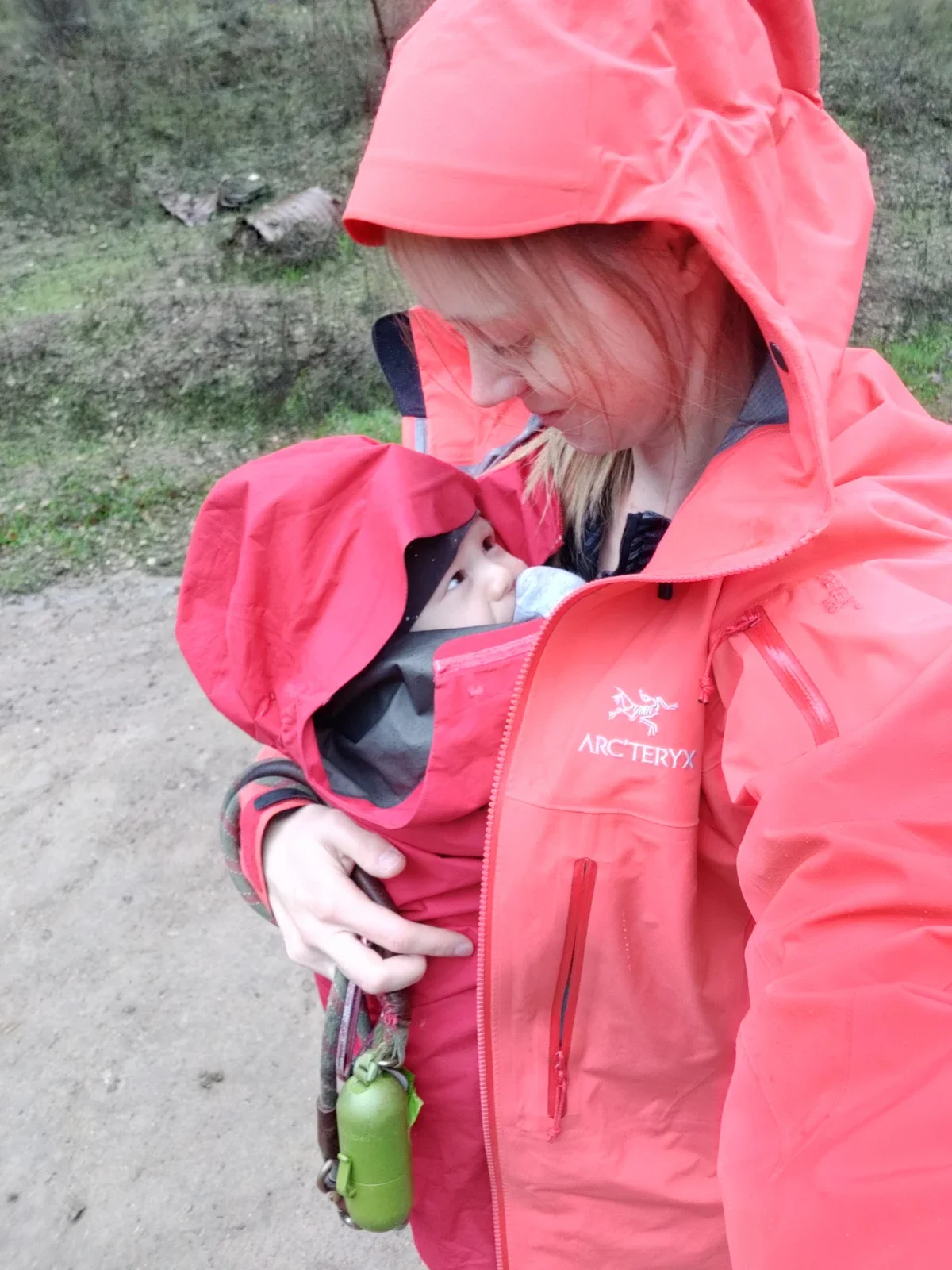 Clare Hennig is pictured holding her son in a front carrier on a walk.