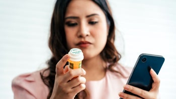 warfarin: woman looking up medication on smartphone 1717854411