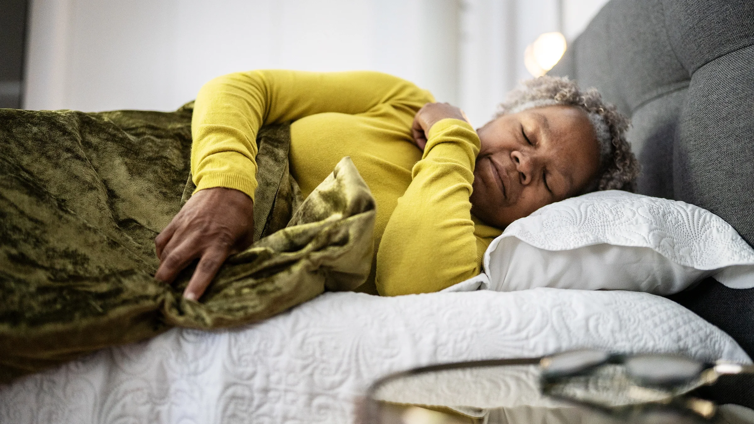 A woman is asleep in bed.