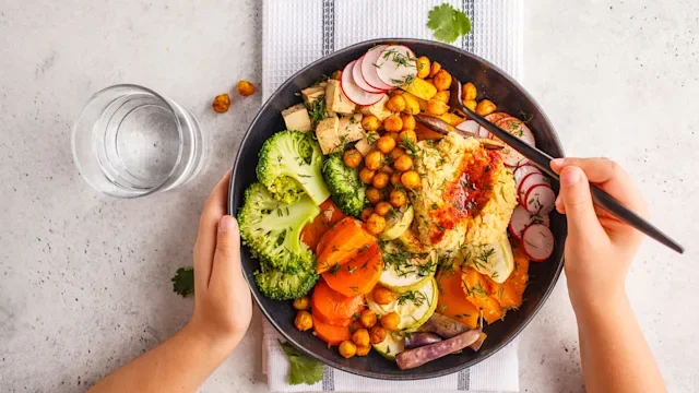 Health: Diet and nutrition: chickpea hummus bowl with greens 1053208202