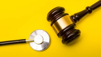 gavel stethoscope yellow background-1188666152