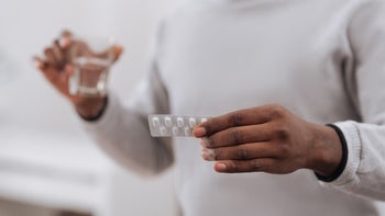 closeup man holding medicine pack 698025480