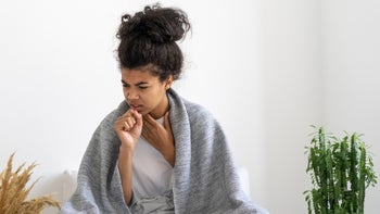 respiratory: sick: cold: flu: cough: woman coughing with blanket around shoulders 1384248800