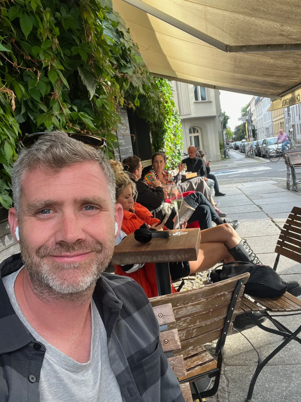 Chris Mills is pictured in a snapshot at an outdoor cafe.
