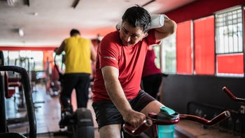 Movement-exercise: man wiping sweat while exercising 1435831612