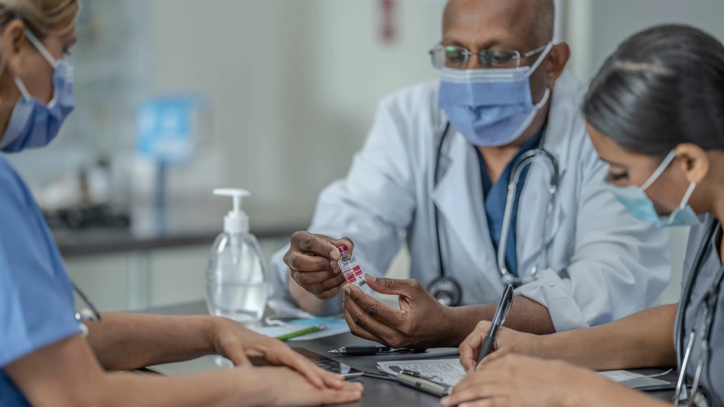 HCPs discussing a vaccine in a meeting.