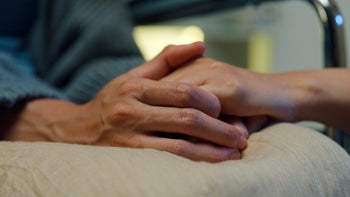end-of-life: closeup hands gripping together 1821643708