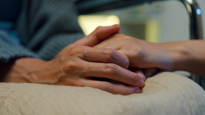 A close-up of hands gripping tightly.