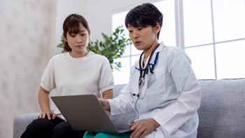 Abortion: Late-term: female patient and doctor on laptop-1417087000