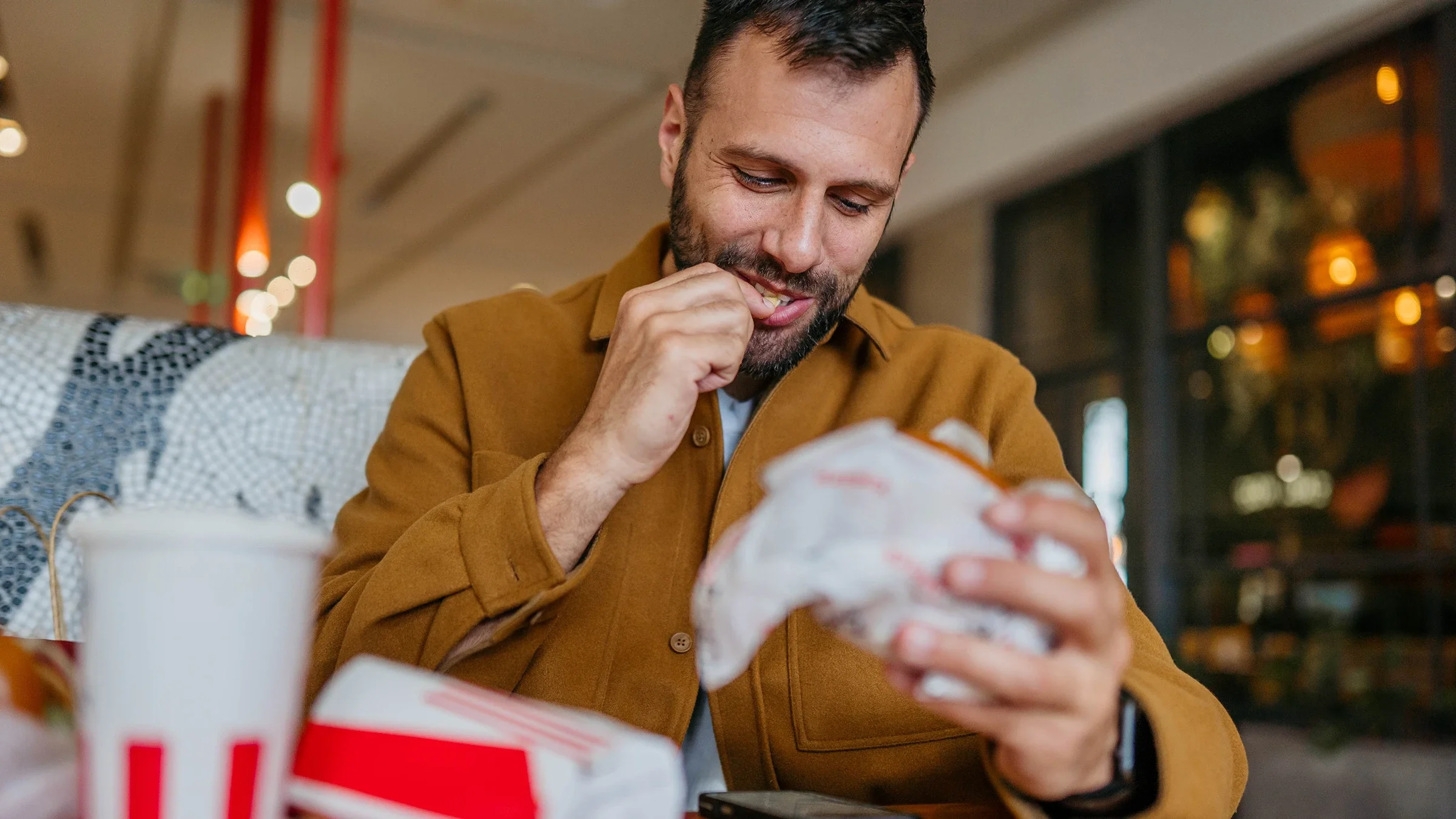 A man eats fast food.