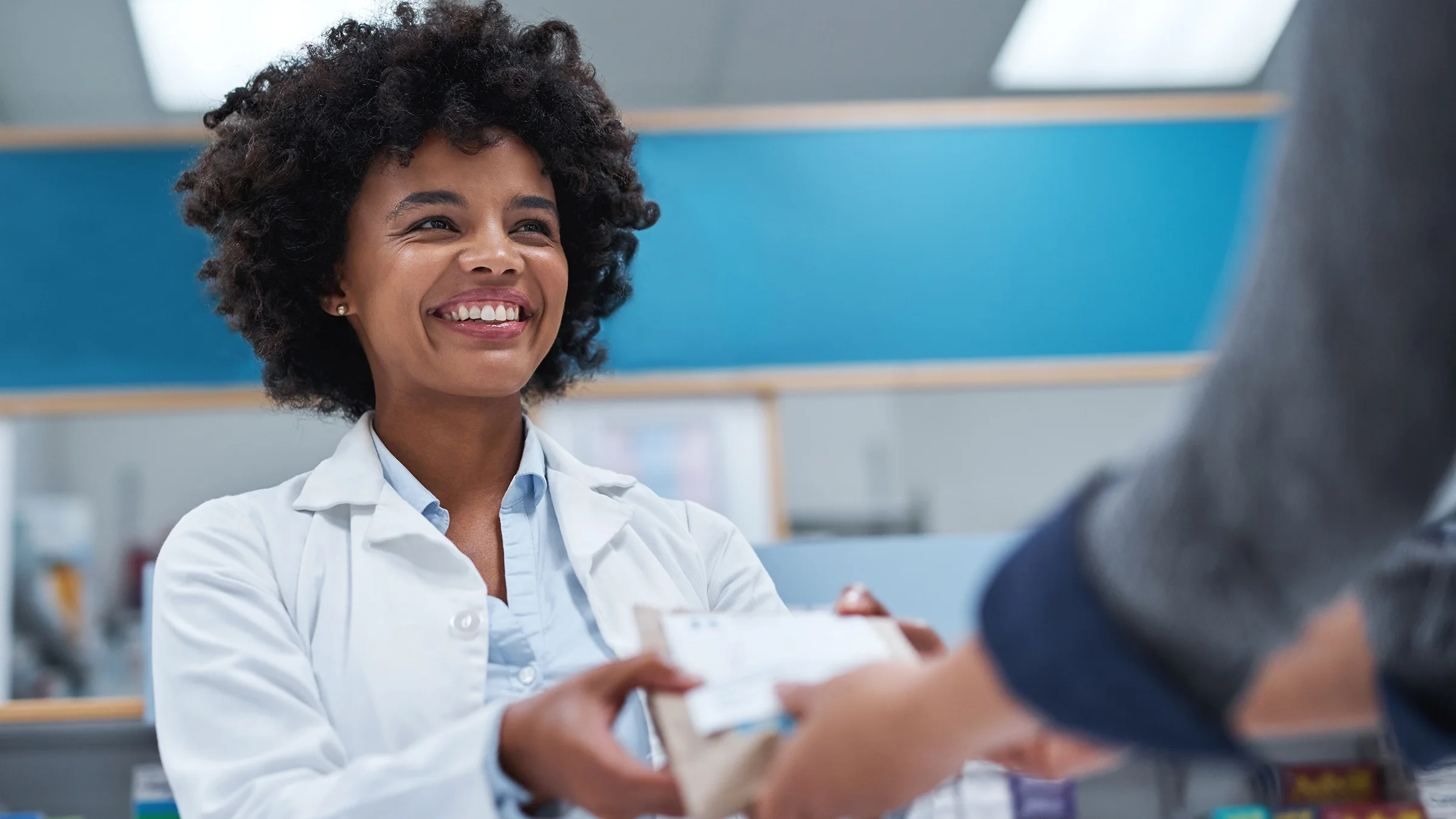 A pharmacist assists a customer.