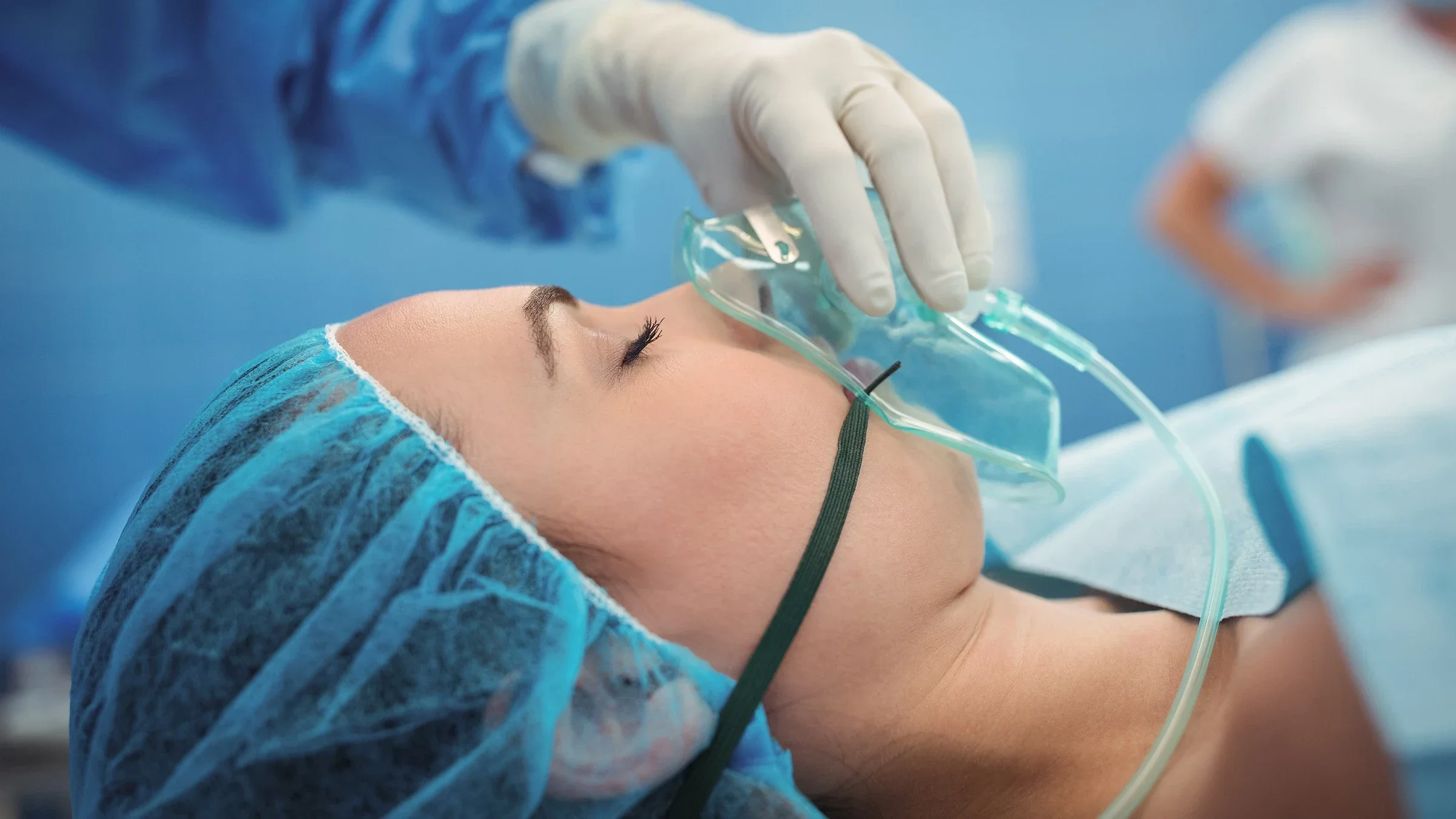 Woman undergoing anesthesia in the operating room. The doctor is adjusting the face mask over her nose and mouth.
Wavebreakmedia/iStock via Getty Images