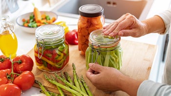 Supplements and herbs: closeup hands with pickled vegetables 1431038475