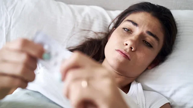 Health: Haloperidol: woman holding blister pack of pills 1383469588