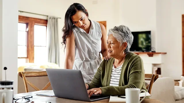 Medicaid: woman helping with a laptop 1181408083