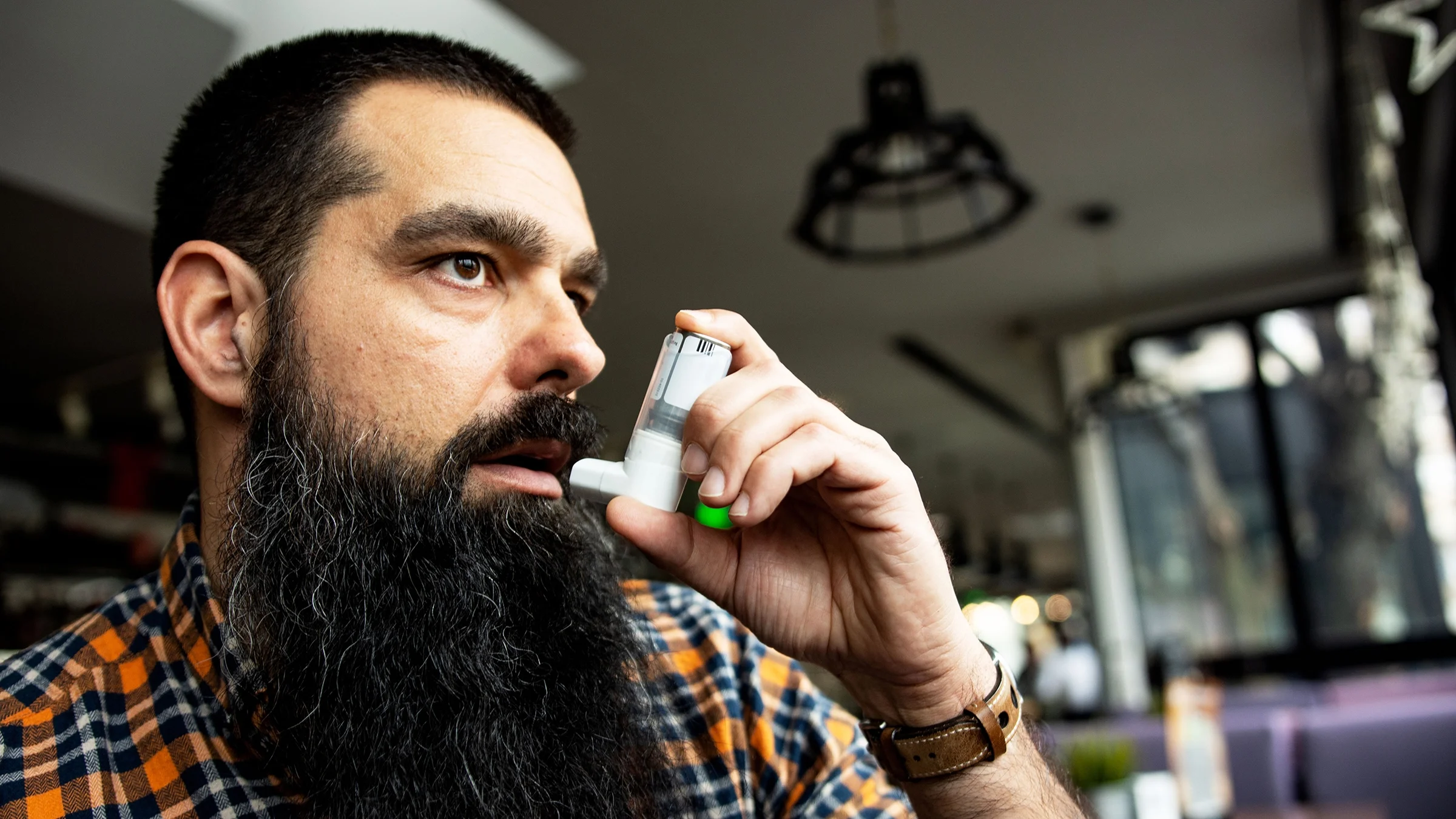 A man uses his inhaler.