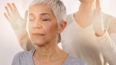 Health: Alternative treatments: energy healing alt treatments senior woman-1125632816
