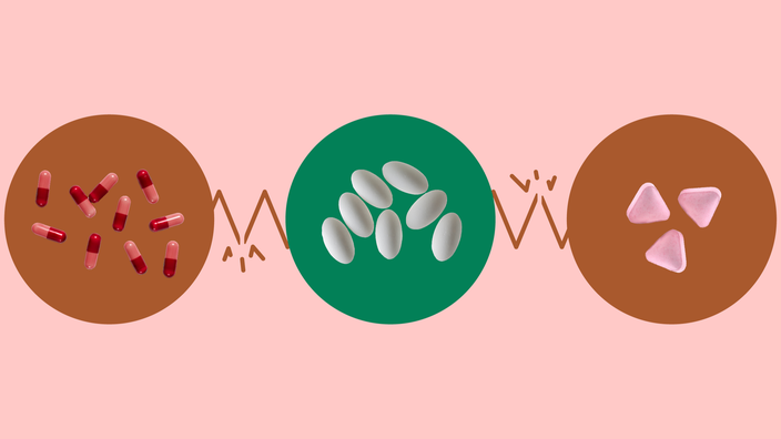 The image shows a light red background with three circles across the frame. In the center, on a green circle, is a pile of white oblong pills. On the left, on a red circle, is a pile of red capsule pills. On the right, on a red circle, is a pile of pink triangular pills.  