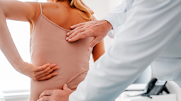 A doctor examines a patient's spine.
Inside Creative House via Getty Images Plus 