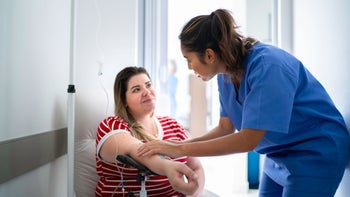 Health: Drug cost and savings: woman receives IV drip 1197650065