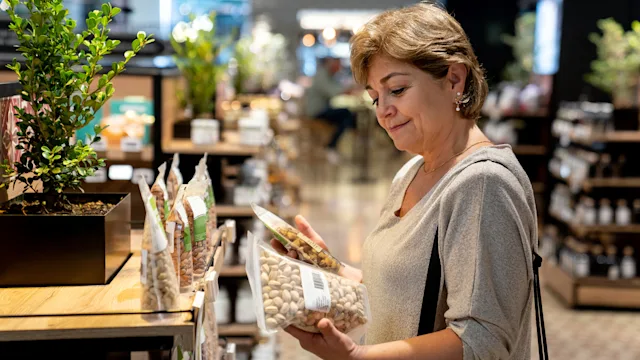 Diet Nutrition: woman shopping for pistachios 1556147796