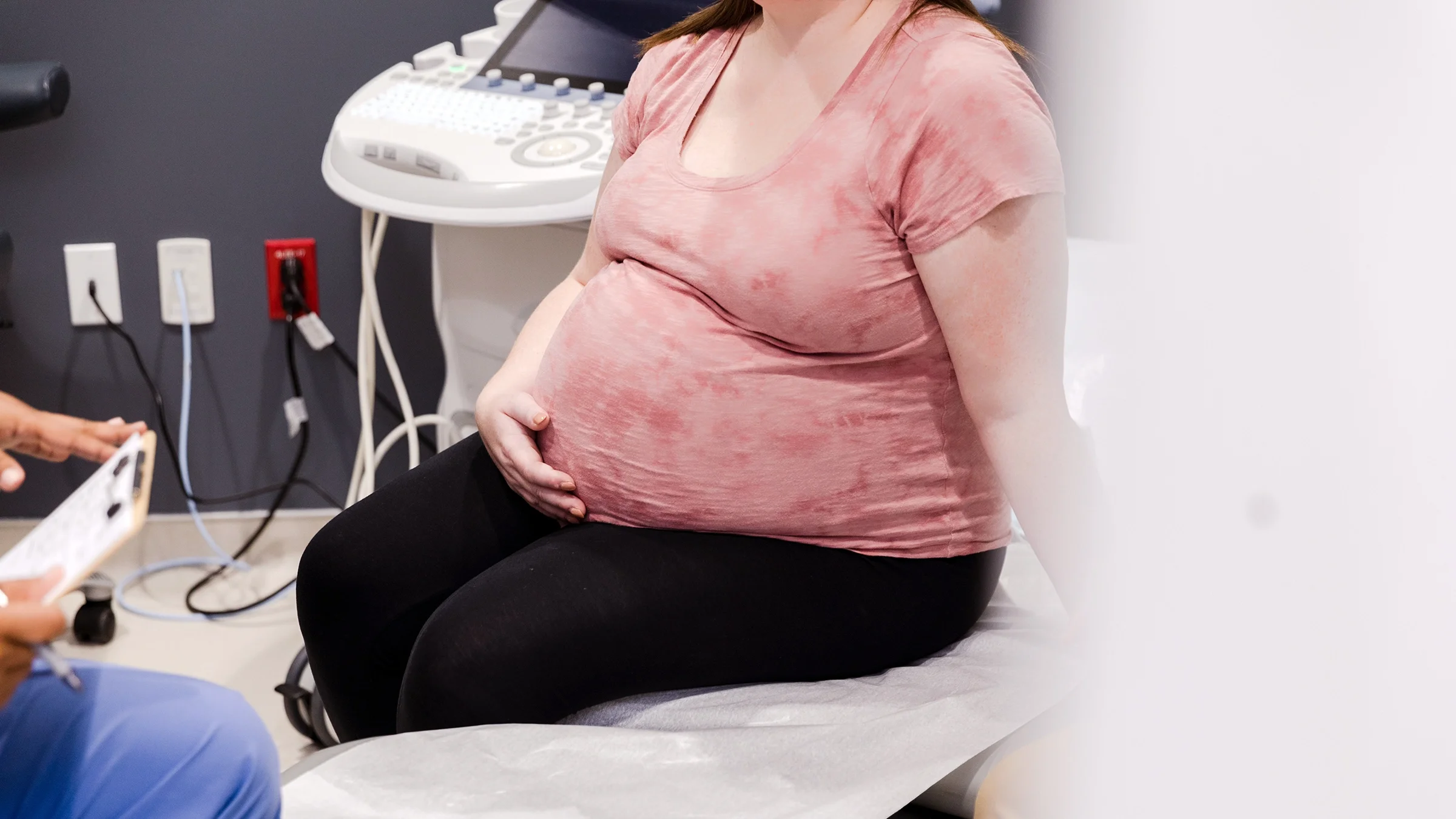 Pregnant woman talking to doctor.