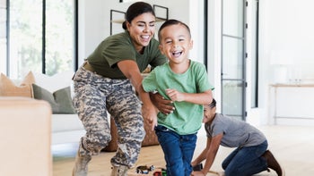 Health: Patient advocacy: female soldier plays with children 1356430957