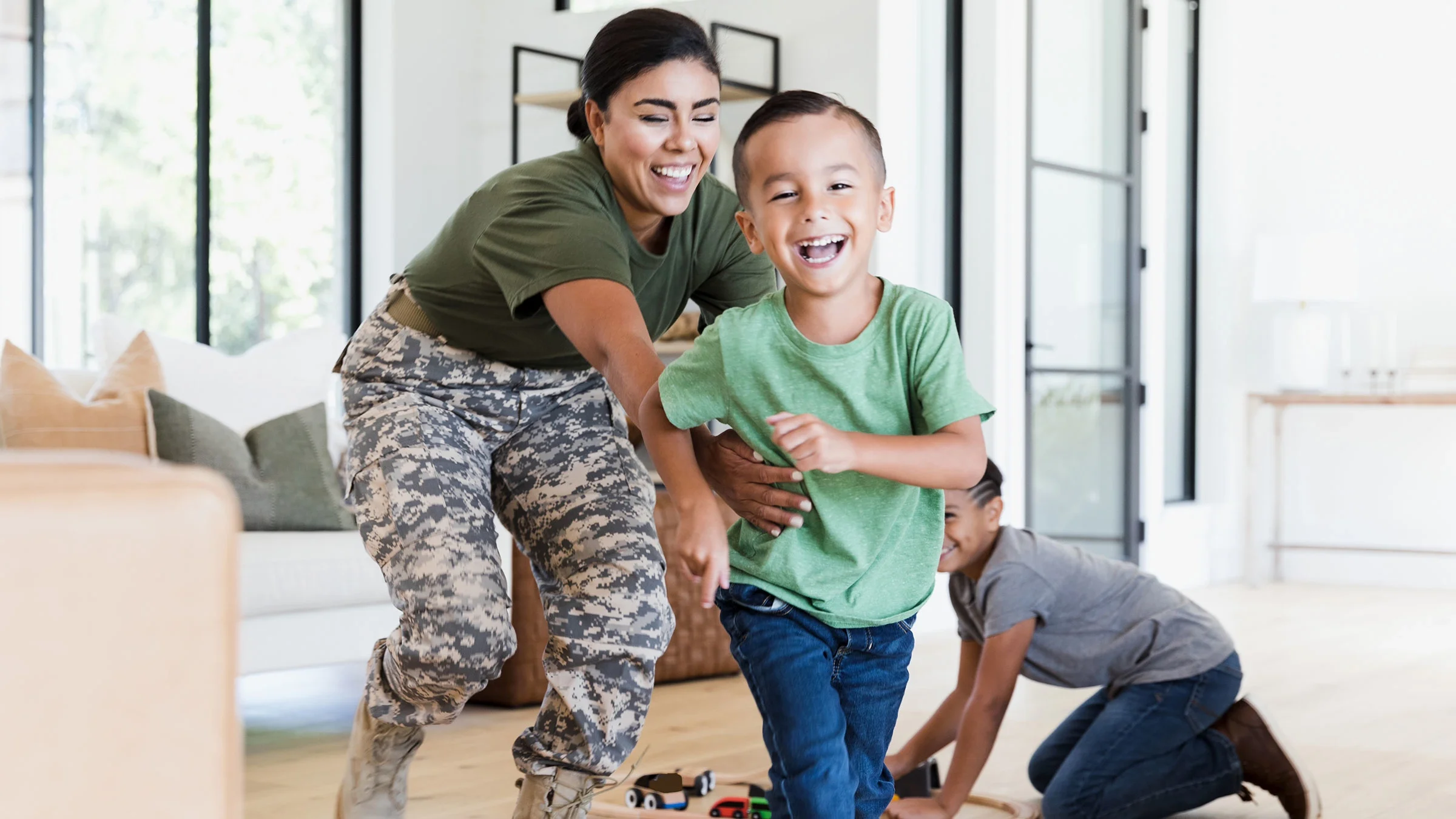 Female soldier plays with children at home.