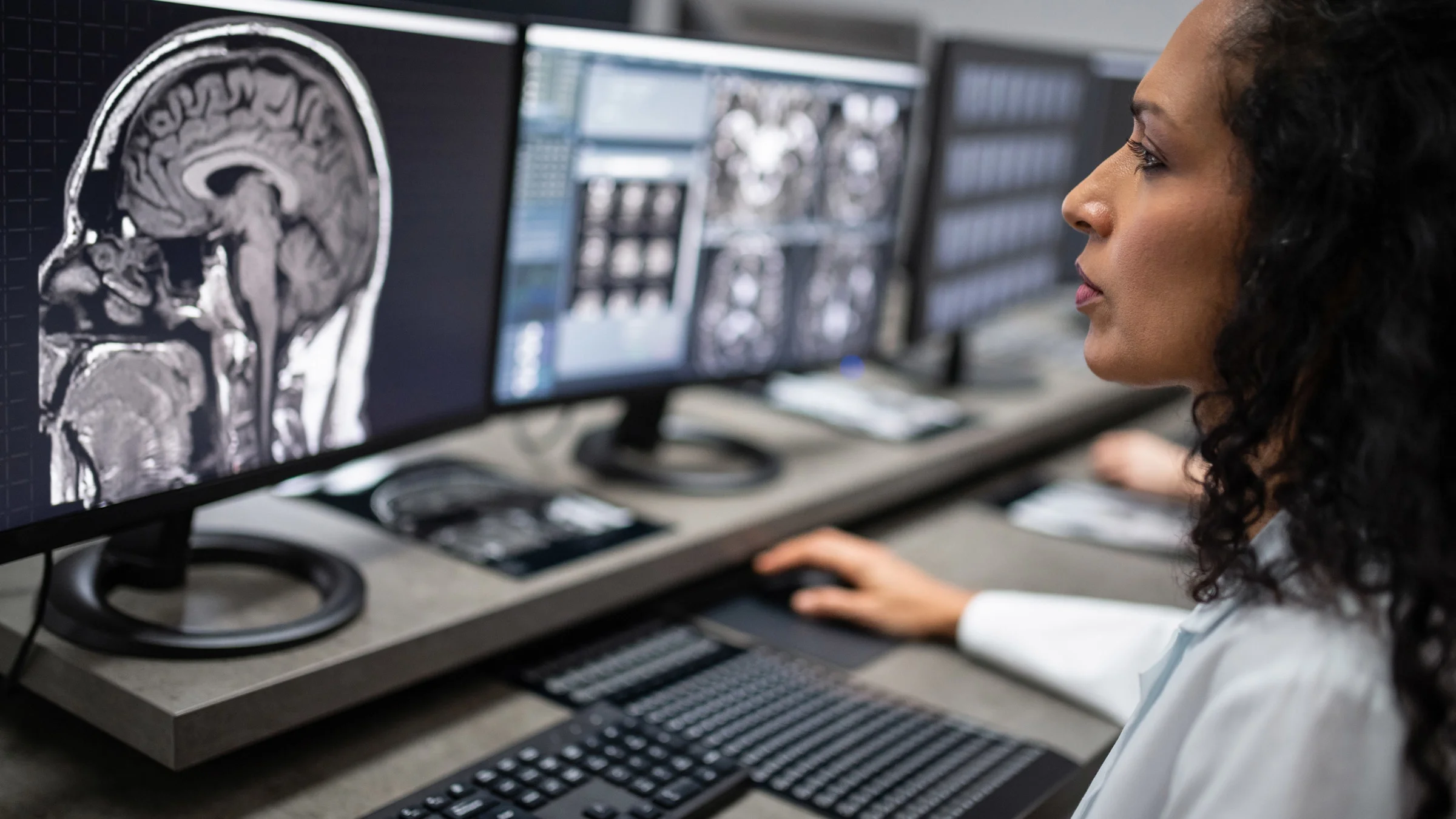 A doctor examining brain scans on their computer.