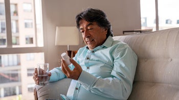 Health: Farxiga: man taking medicine with water 1265265530