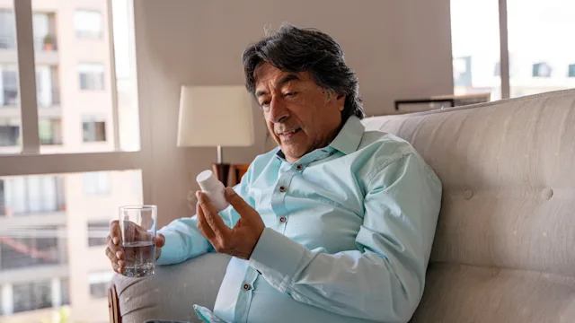 Health: Farxiga: man taking medicine with water 1265265530