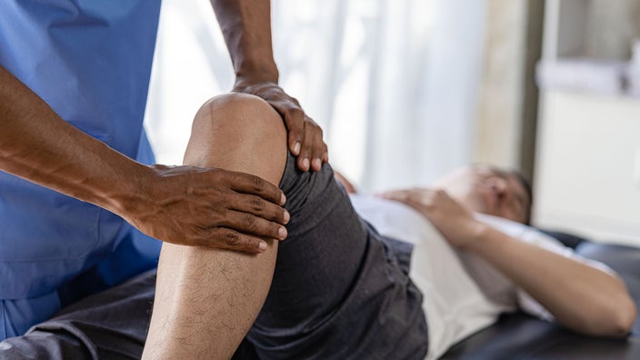 Close-up knee physical therapy.