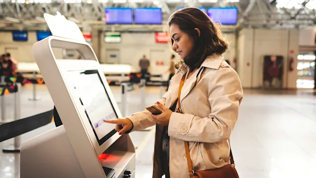 Pharmacists: Abroad: side profile airport check-in-1162651759