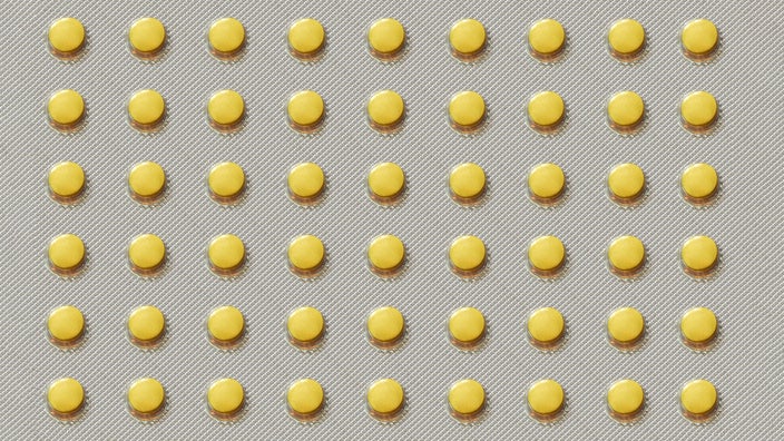 A blister pack of round yellow pills.