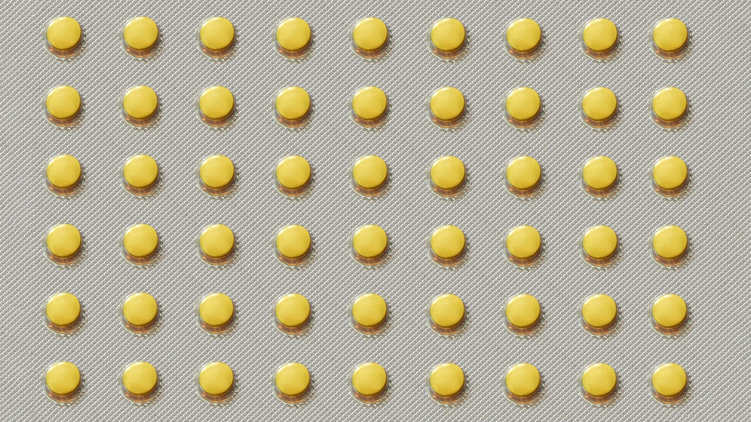 A blister pack of round yellow pills.
