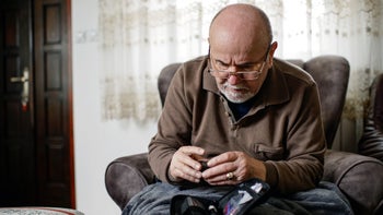 Health: Diabetes: senior man checking blood sugar 1307985222