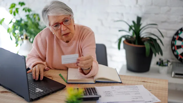 Medicare: Job-based insurance: older adult paying bill 1399367514