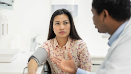 A HCP takes a woman's blood pressure.
vm/E+ via Getty Images 