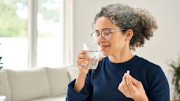 A woman is taking a pill with a glass of water.
insta_photos/iStock via Getty Images Plus