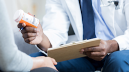 A cropped shot of a doctor explaining a pill bottle to a patient.
SDI Productions/iStock via Getty Images 