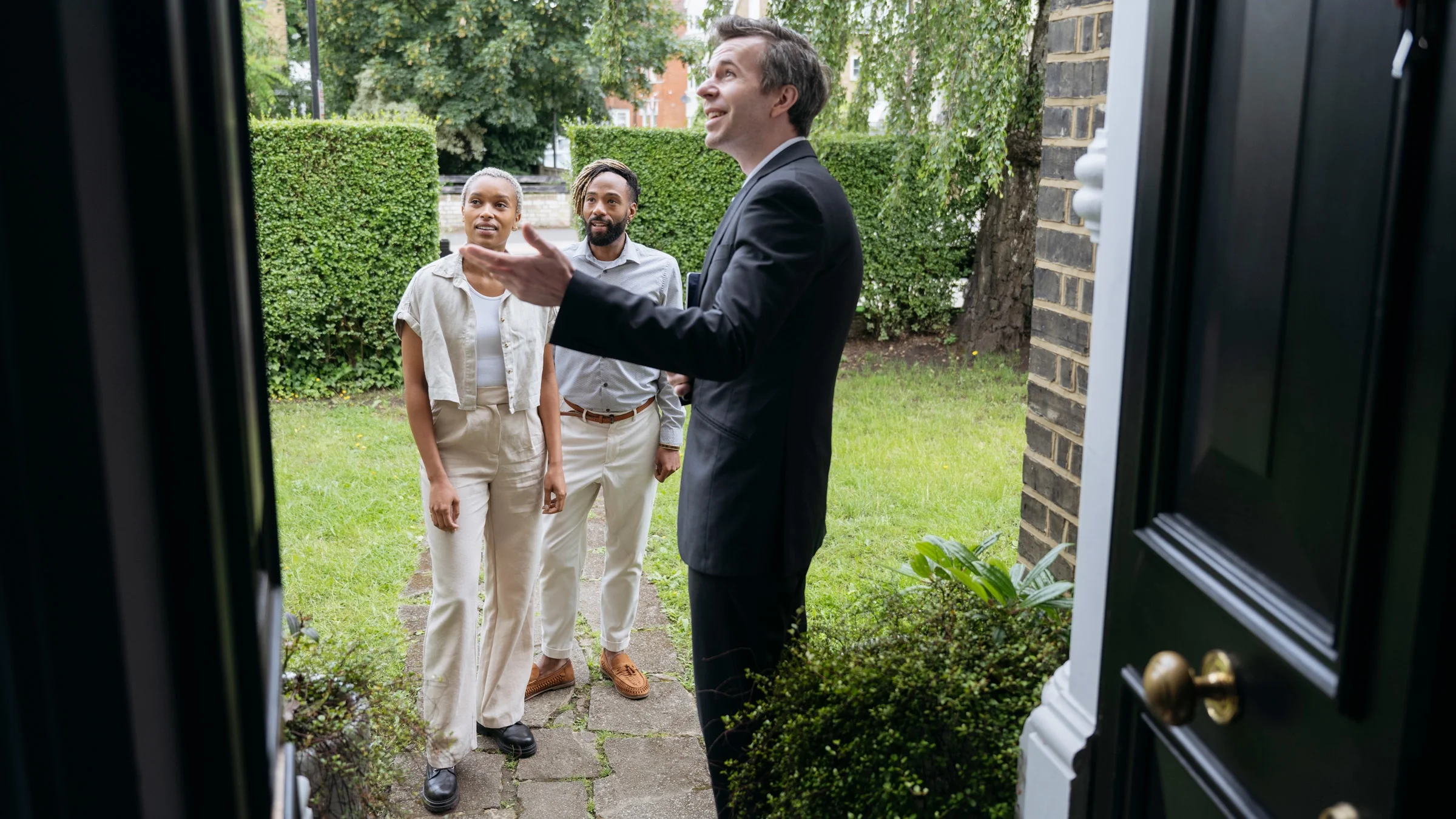 A realtor showing a house to a couple.