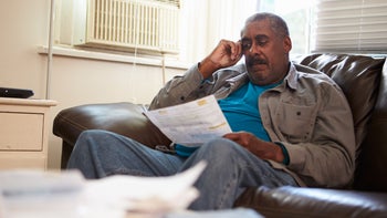 Medicare: Part A: worried older man looking at bIill 494765433