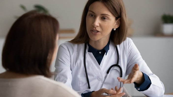 Close-up doctor talking with patient.