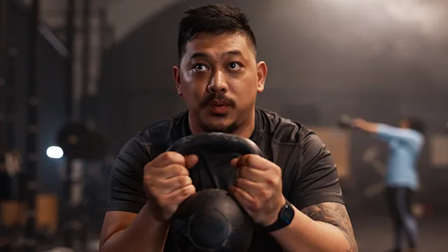 Movement-exercise: man exercising with kettle bell 1352379152