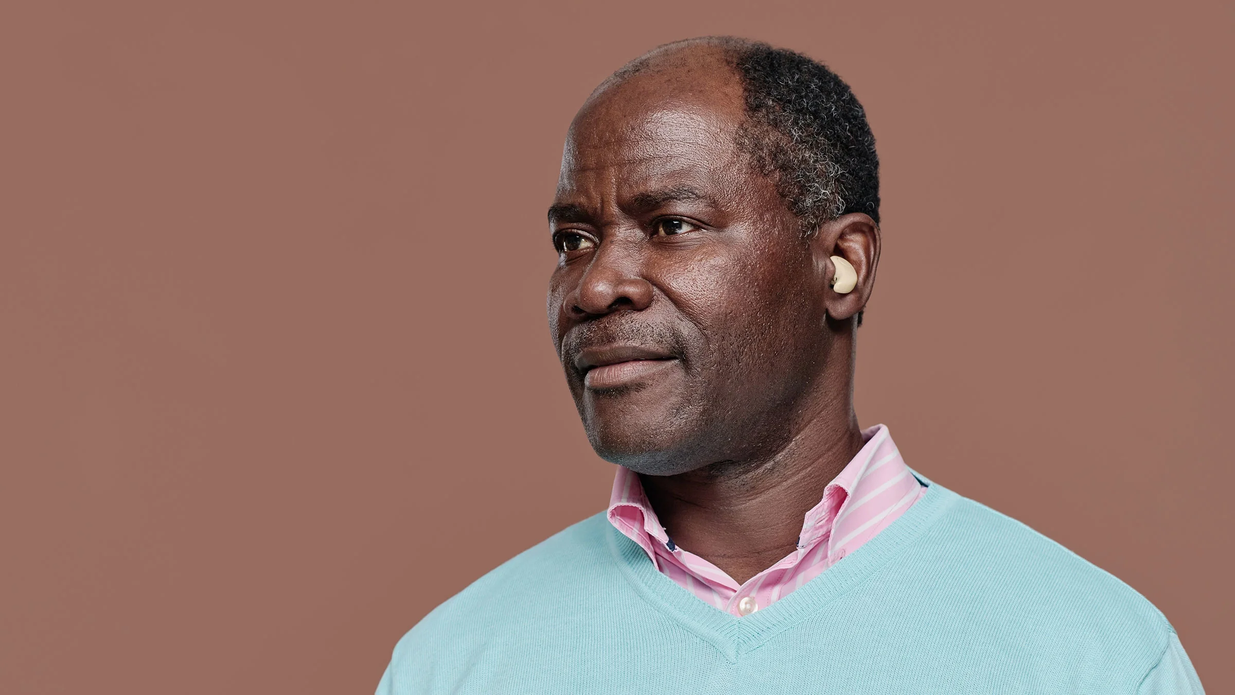 A man with hearing aids is pictured in a portrait.