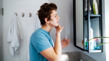 Acne: teenager washes his face 1460847679