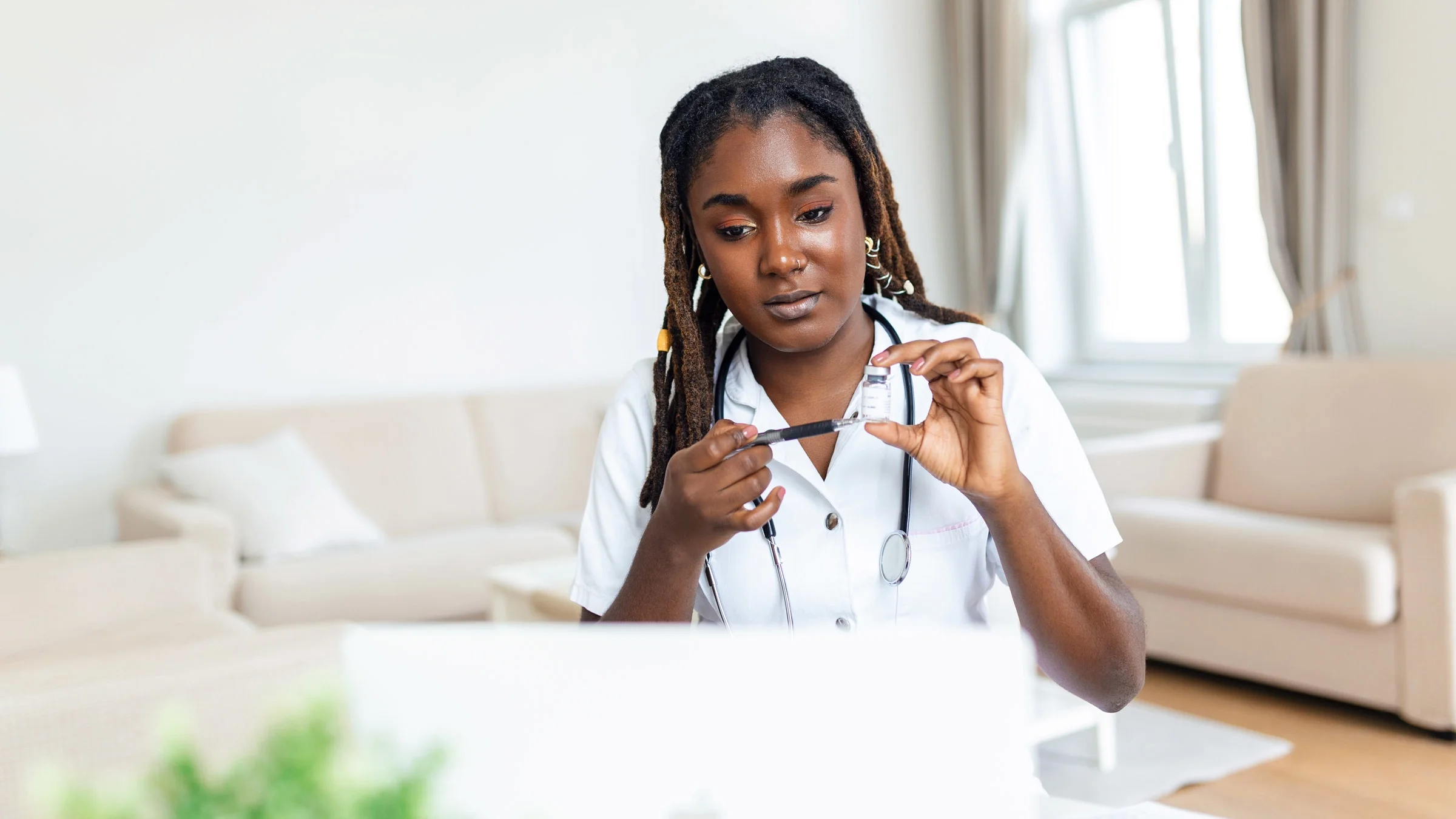 A doctor explaining a vial over telehealth.
