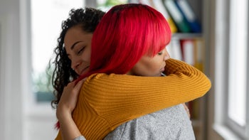 Mental health: Relationship abuse: consoling friend with hug 1397693634